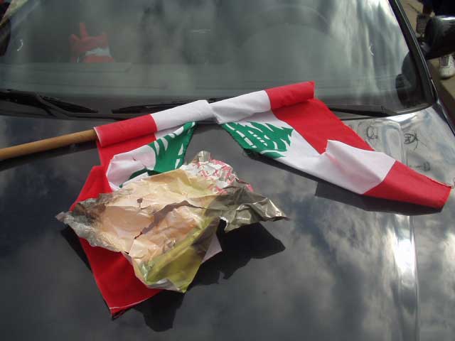 Lebanese flag torn by security forces